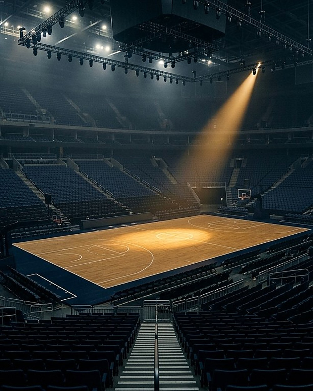 Empty basketball arena, gold spotlight on the court
