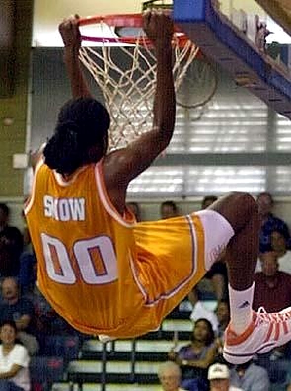 Michelle Snow hanging from the rim after a dunk in her gold Tennessee uniform, number 00